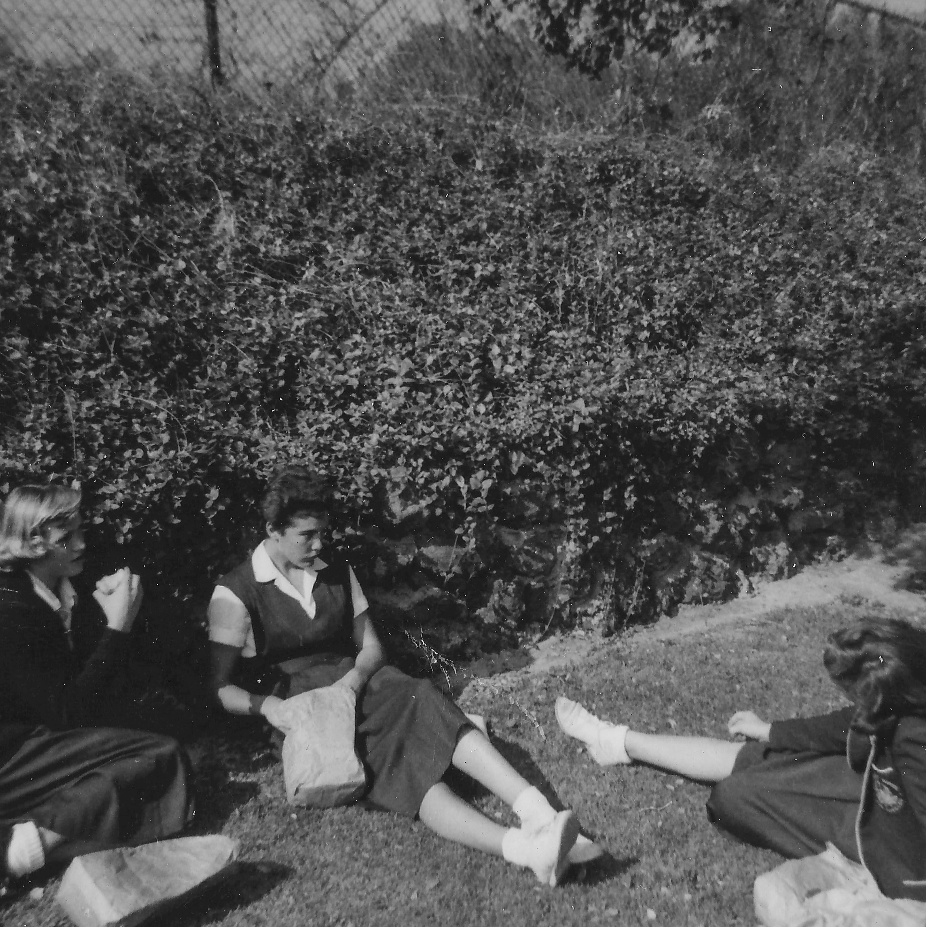 Women leaning on fence