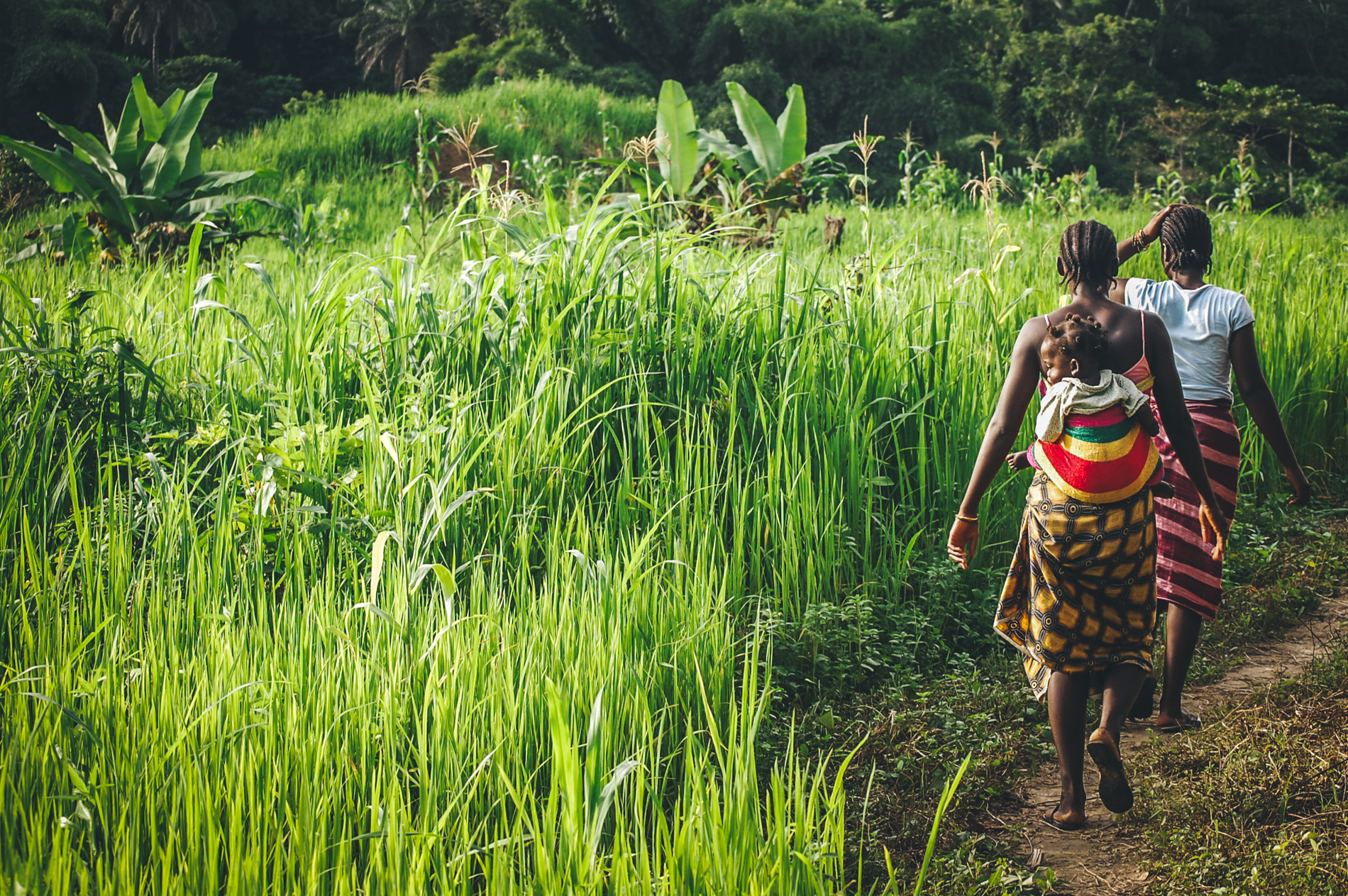 woman and child walking through the jungle