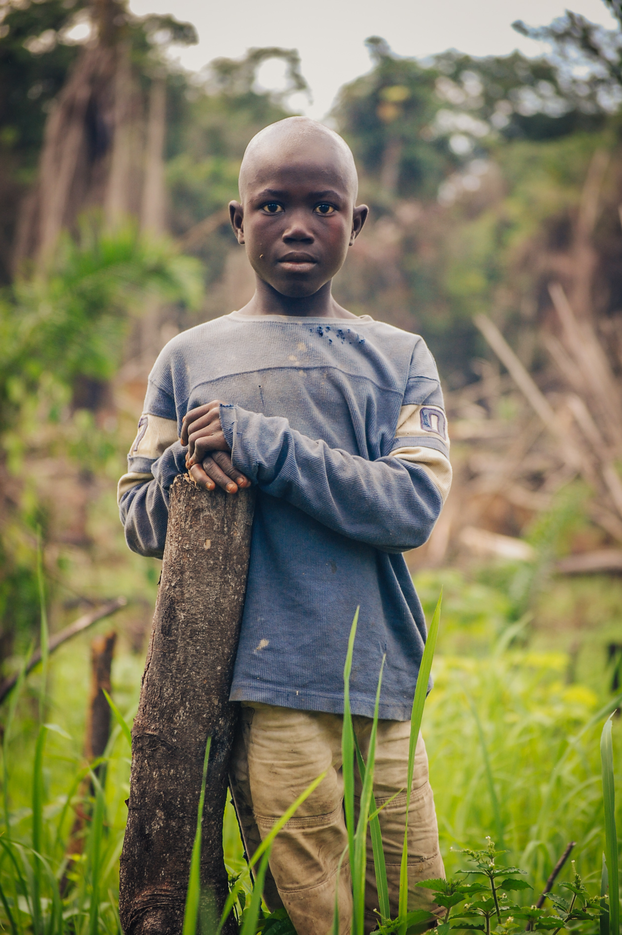 young boy in village looking into camera