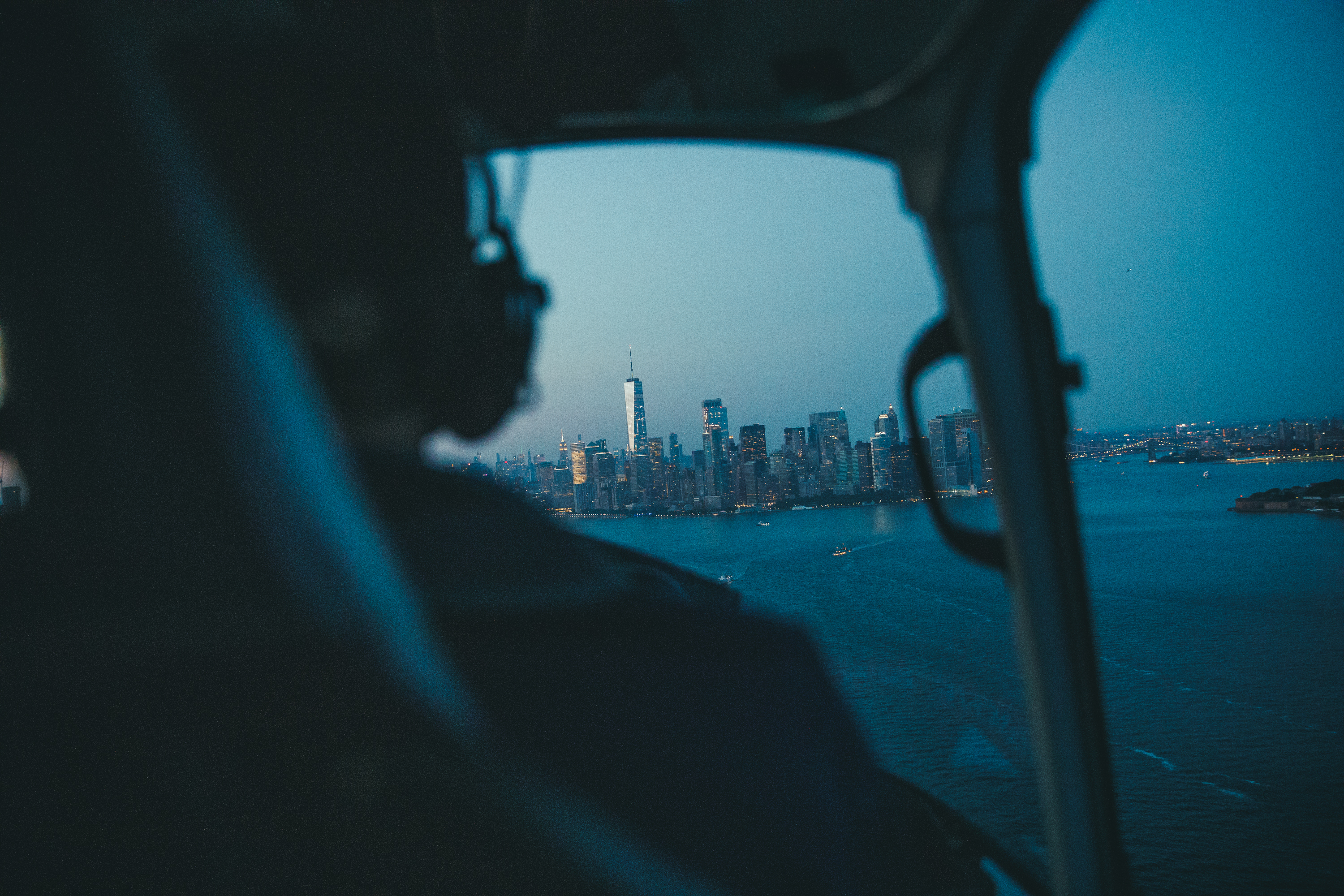 Pilot flying helicopter to city