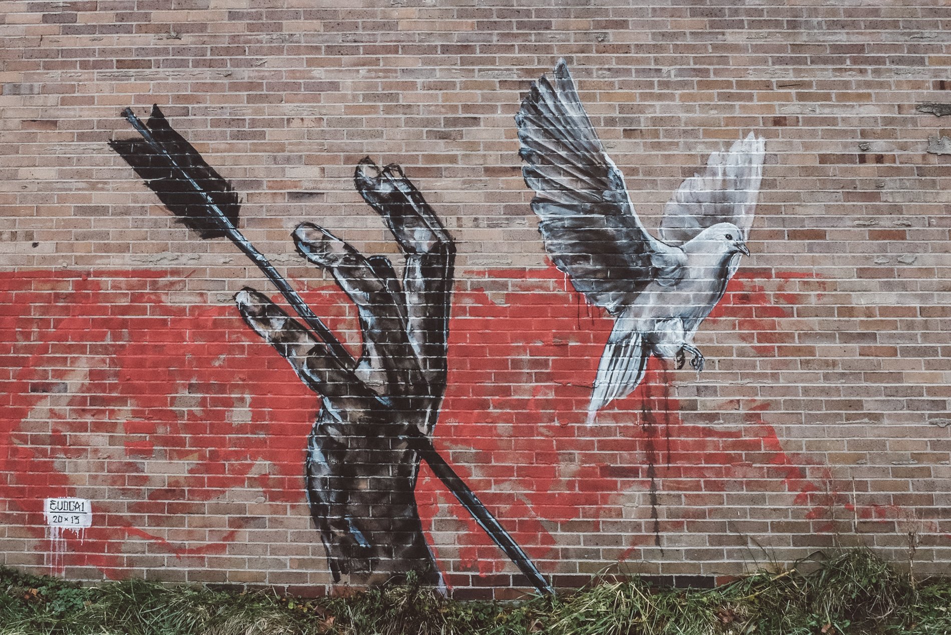 hand pierced with arrow beside dove