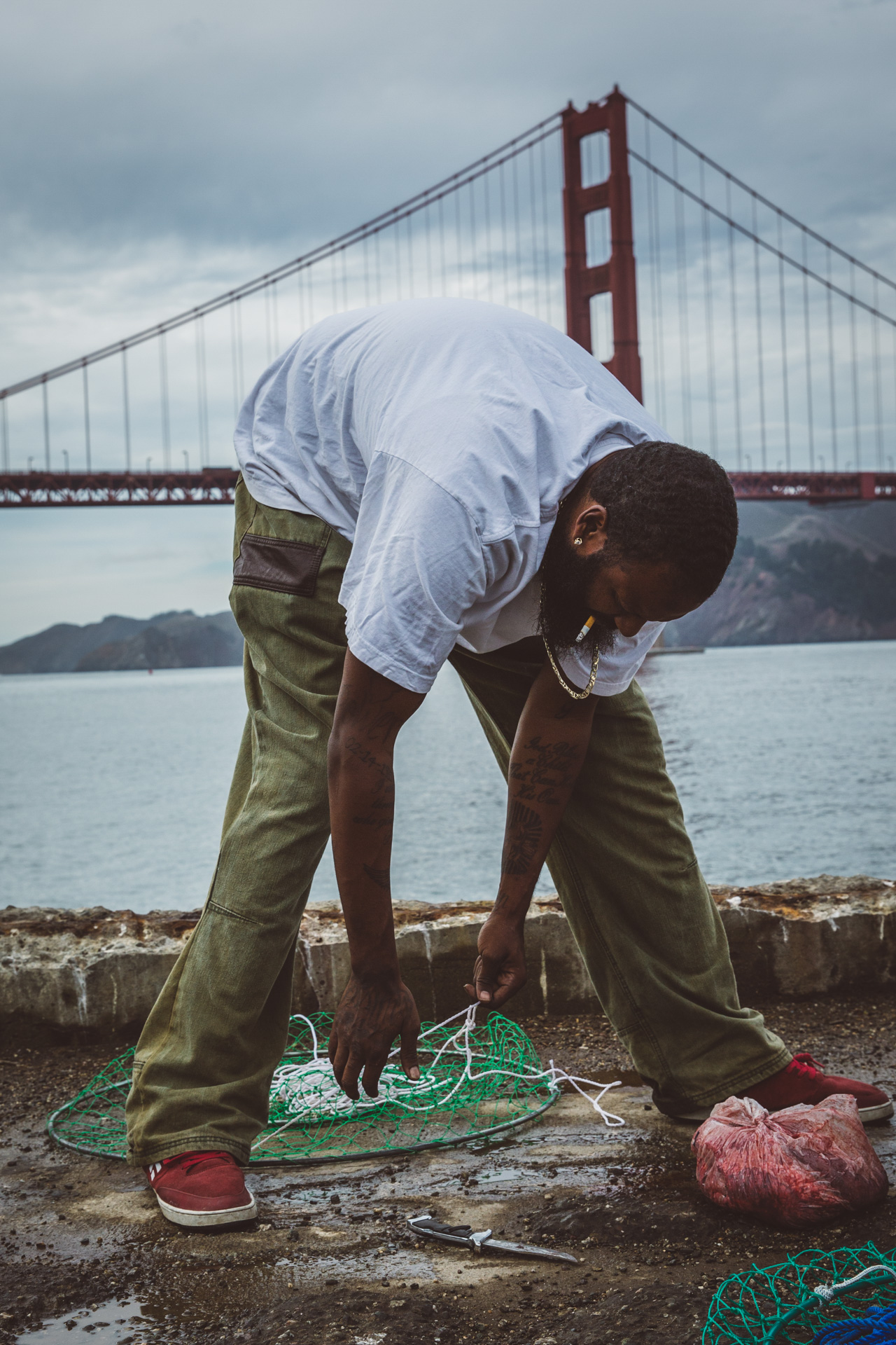 man fishing by golden gate bridge