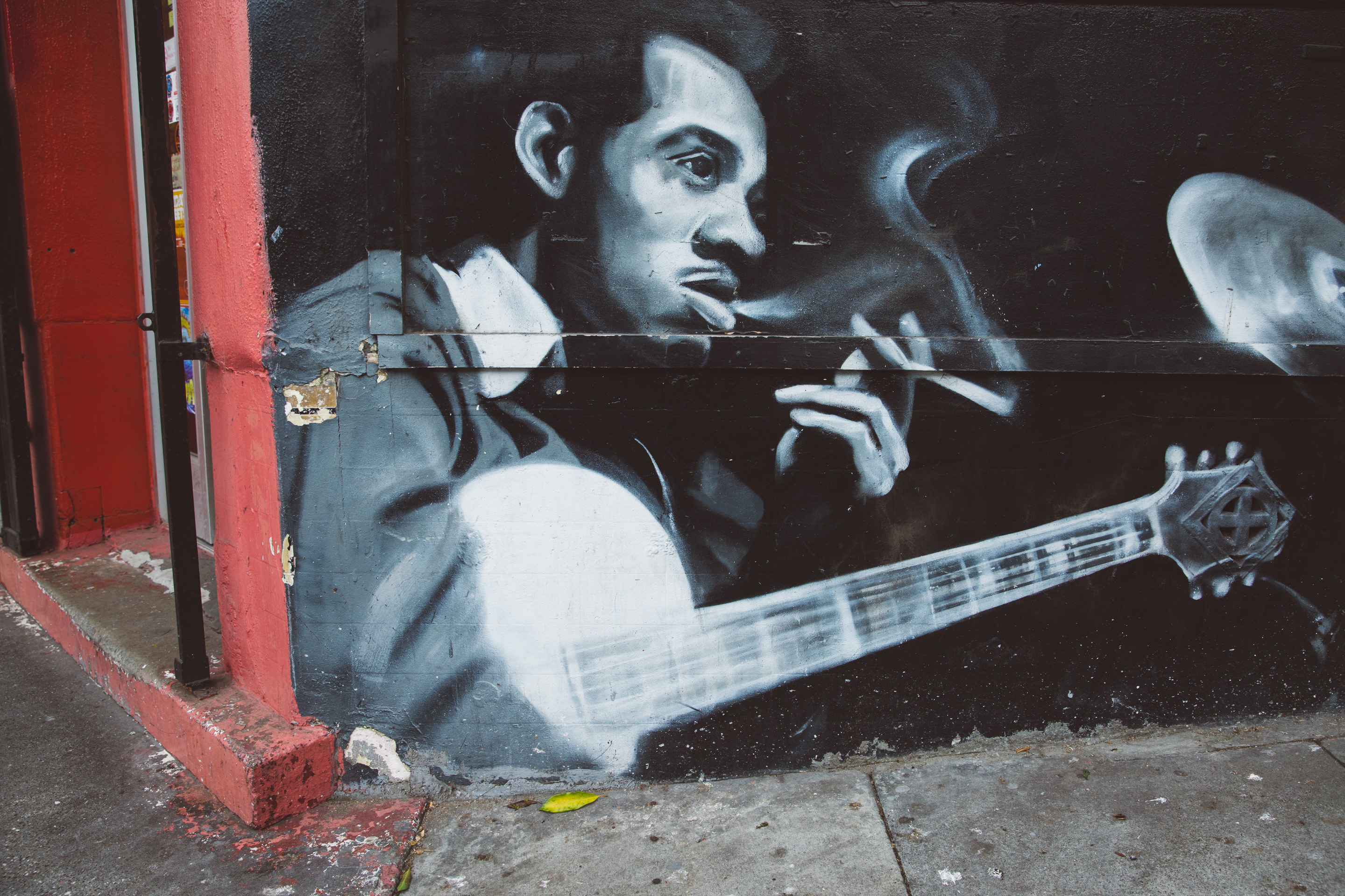 graffiti wall art playing guitar and smoking