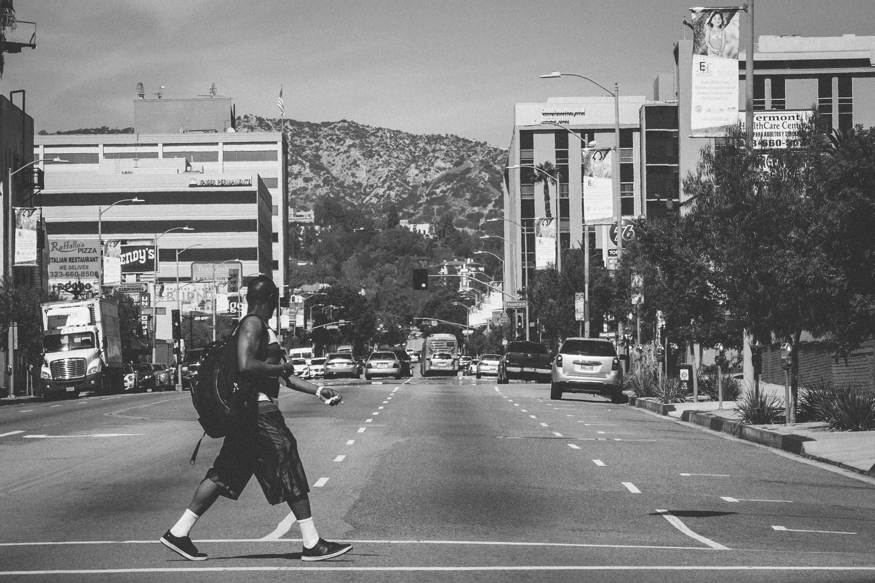 man walking across the street