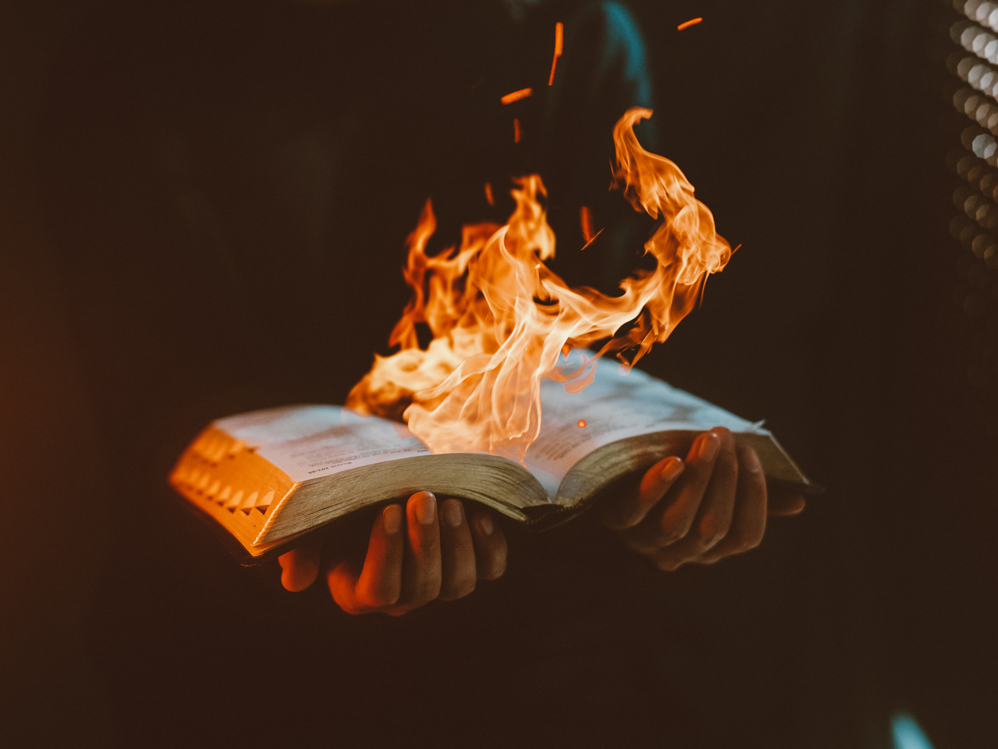 Holding bible on fire