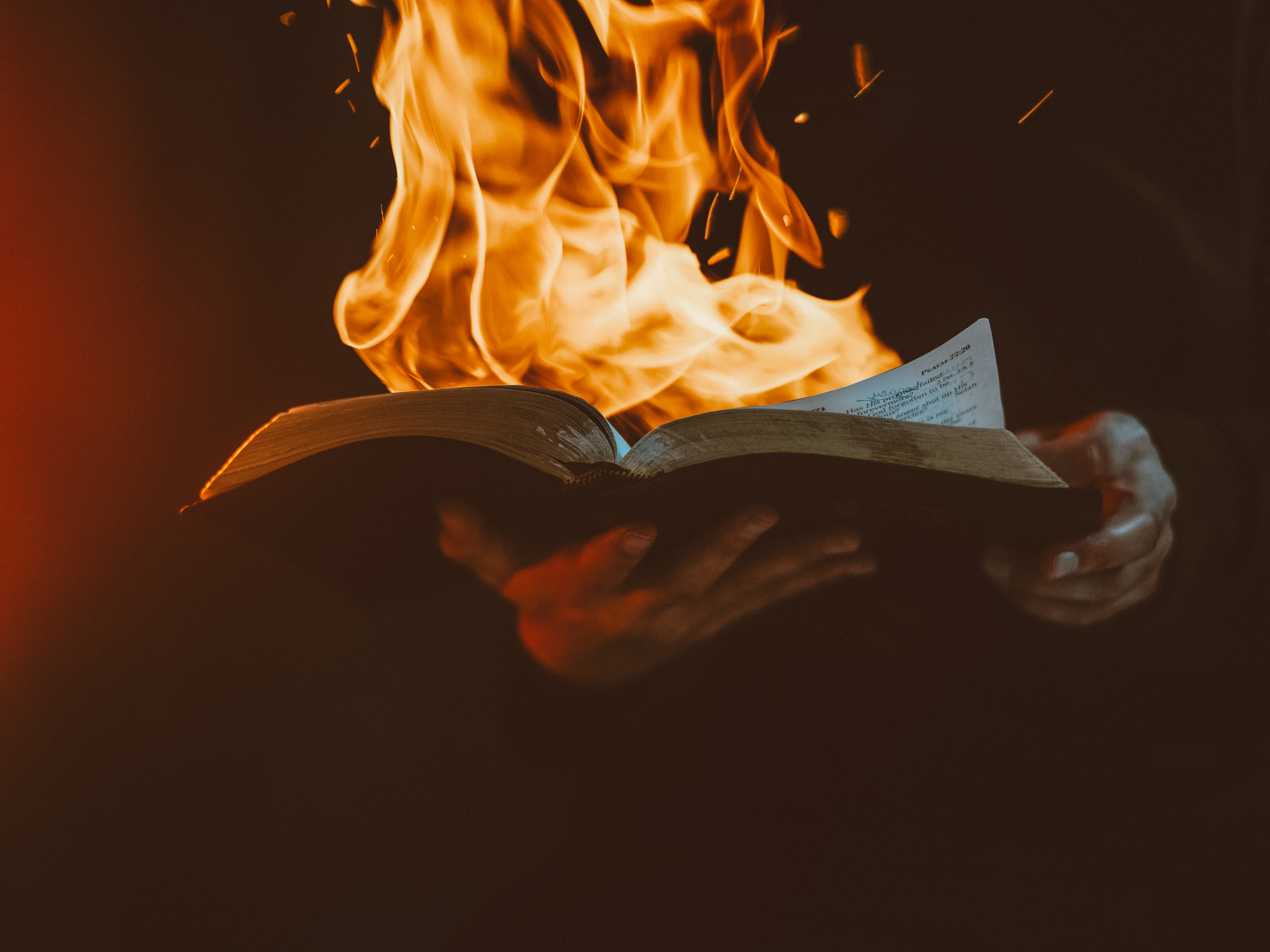 Turning page of bible on fire